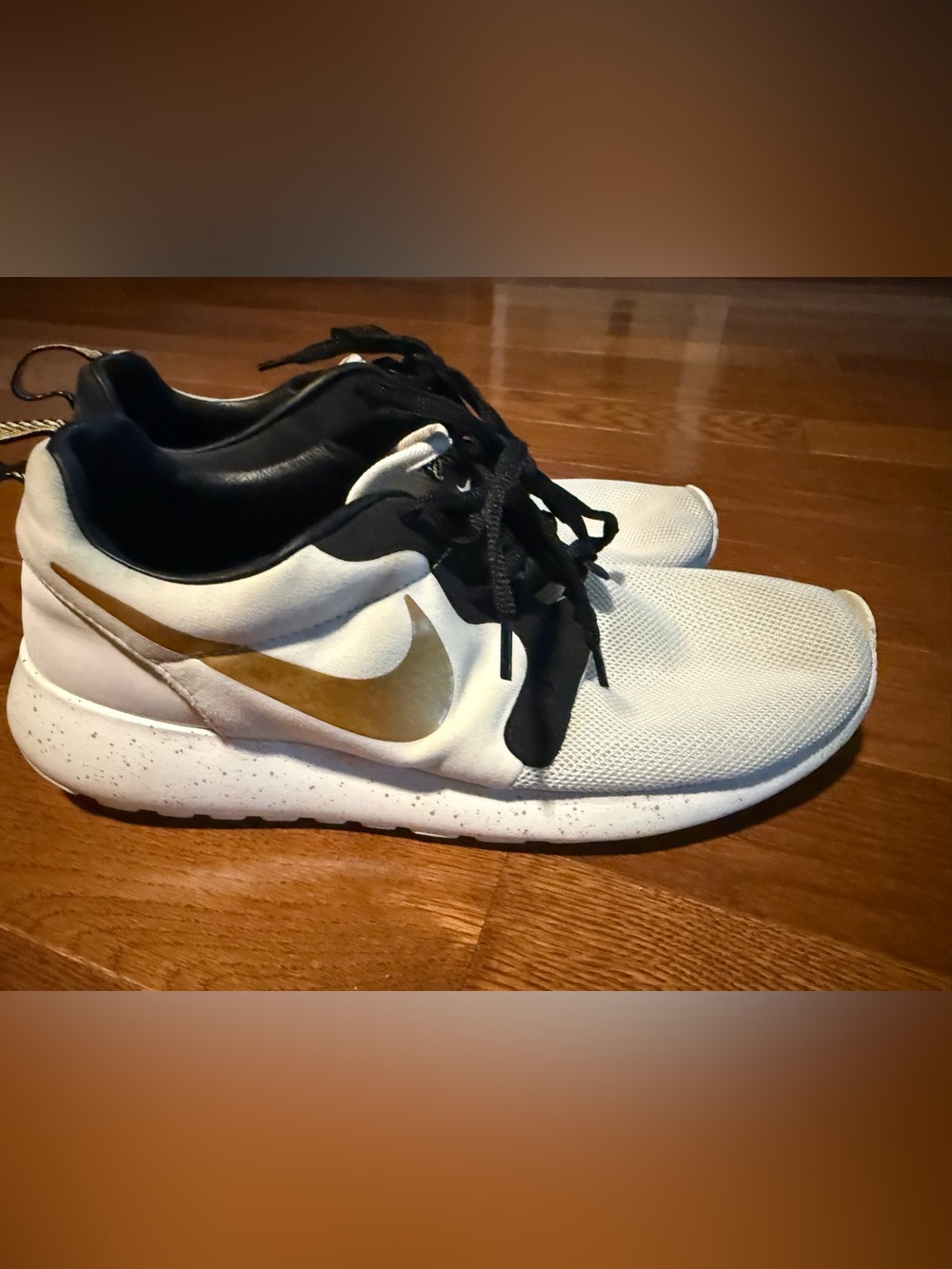 Nike men’s White and Black Running Shoes with Gold Swoosh